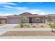 Inviting single-story home with a well-kept front yard, desert landscaping, and a convenient two-car garage at 17051 W West Wind Dr, Surprise, AZ 85387