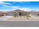 Charming single-story home featuring a well-maintained front yard with desert landscaping and a two-car garage at 17051 W West Wind Dr, Surprise, AZ 85387