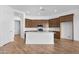 Bright kitchen with large island, stainless appliances, and dark wood cabinets at 17051 W West Wind Dr, Surprise, AZ 85387
