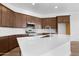 Modern kitchen with stainless steel appliances, a large island, and white subway tile backsplash at 17051 W West Wind Dr, Surprise, AZ 85387