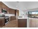 Open concept kitchen with large island, stainless appliances and views of the outdoor patio at 17051 W West Wind Dr, Surprise, AZ 85387