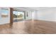Spacious living room with wood floors and natural light from sliding glass doors to the outdoor patio at 17051 W West Wind Dr, Surprise, AZ 85387