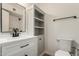 Modern bathroom with white vanity, black fixtures, built-in storage, and neutral paint at 1959 E Orion St, Tempe, AZ 85283