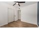 Bright bedroom features hardwood floors, ceiling fan, and sliding closet doors at 1959 E Orion St, Tempe, AZ 85283