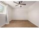 Bright bedroom features wood-look floors, a ceiling fan, and a large window at 1959 E Orion St, Tempe, AZ 85283