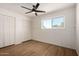 Bedroom with wood-look floors, board and batten accent wall, and ample closet space at 1959 E Orion St, Tempe, AZ 85283