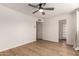 Bright bedroom features wood-look floors, a modern ceiling fan, and a neutral color palette at 1959 E Orion St, Tempe, AZ 85283