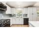 Modern kitchen with white cabinets, quartz countertops, and stainless steel appliances at 1959 E Orion St, Tempe, AZ 85283