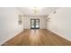 Spacious living room with wood floors, modern lighting, and door to backyard at 1959 E Orion St, Tempe, AZ 85283