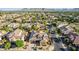 Expansive aerial view highlights a neighborhood with mature trees, well-maintained homes, and mountain views at 20211 E Via Del Oro --, Queen Creek, AZ 85142