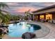 Stunning backyard pool features a rock waterfall, lush landscaping, and ample space for outdoor enjoyment and relaxation at 20211 E Via Del Oro --, Queen Creek, AZ 85142