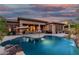 Beautiful backyard pool with waterfall features and poolside lounge area, perfect for outdoor entertaining and relaxation at 20211 E Via Del Oro --, Queen Creek, AZ 85142