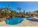 Beautiful backyard pool featuring a rock waterfall, palm trees, and ample space for outdoor fun and relaxation at 20211 E Via Del Oro --, Queen Creek, AZ 85142
