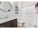 Bathroom features a single sink, white countertops, dark cabinets, and shower with decorative curtain at 20211 E Via Del Oro --, Queen Creek, AZ 85142