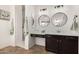 Modern bathroom with a double circular mirror over vanity, dark cabinets, and step in shower at 20211 E Via Del Oro --, Queen Creek, AZ 85142