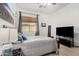 Inviting bedroom with soft lighting, laminate floors, and television at 20211 E Via Del Oro --, Queen Creek, AZ 85142