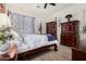 Comfortable bedroom with a four-poster bed, elegant decor, and laminate floors at 20211 E Via Del Oro --, Queen Creek, AZ 85142
