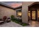 Charming courtyard entry with comfortable seating and lush landscaping at 20211 E Via Del Oro --, Queen Creek, AZ 85142
