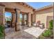Covered outdoor living space offering shaded seating and lush garden views at 20211 E Via Del Oro --, Queen Creek, AZ 85142