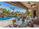 Relaxing covered patio overlooking a beautiful pool and lush landscaping, providing a tranquil space for outdoor enjoyment at 20211 E Via Del Oro --, Queen Creek, AZ 85142