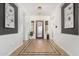 Inviting foyer with decorative tile flooring, art niches, and statement lighting at 20211 E Via Del Oro --, Queen Creek, AZ 85142