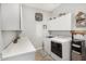 Bright laundry room features a washer, dryer, cabinets, counter and shelving, providing ample space for laundry tasks at 20211 E Via Del Oro --, Queen Creek, AZ 85142