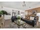 Beautiful living room with leather sofa, chandelier, and glass coffee table at 20211 E Via Del Oro --, Queen Creek, AZ 85142