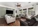 Stylish living room with hardwood flooring, neutral tones, and an entertainment center at 20211 E Via Del Oro --, Queen Creek, AZ 85142