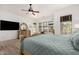 Comfortable main bedroom boasts wood floors, ceiling fan, and a beautiful wooden dresser with mirror at 20211 E Via Del Oro --, Queen Creek, AZ 85142