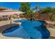 Inviting backyard pool with mature tropical landscaping and a rock waterfall feature at 20211 E Via Del Oro --, Queen Creek, AZ 85142