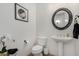 Neat powder room featuring a pedestal sink, modern fixtures, and white walls at 20211 E Via Del Oro --, Queen Creek, AZ 85142