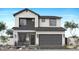Modern two-story home showcasing a gray facade, a gray two-car garage door and stone accents at 2096 E Mill Rd, San Tan Valley, AZ 85140
