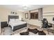 Cozy bedroom features a gray bed frame, a workspace, and a cowhide rug at 2108 E Patrick Ln, Phoenix, AZ 85024