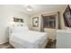 Bright bedroom with a full size bed, wood-look floors, and a large window at 2108 E Patrick Ln, Phoenix, AZ 85024