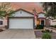 Charming home featuring stone accents, white stucco and a two-car garage, and desert landscaping at 2108 E Patrick Ln, Phoenix, AZ 85024