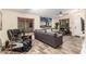 Spacious living room featuring a sectional sofa, ceiling fan, and wood-look floors at 2108 E Patrick Ln, Phoenix, AZ 85024