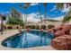 Beautiful backyard pool features a rock waterfall and lush landscaping at 2108 E Patrick Ln, Phoenix, AZ 85024