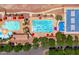 A vibrant aerial view of the community pools, basketball court, and surrounding green spaces at 2120 N Heritage St, Buckeye, AZ 85396