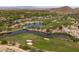 Scenic aerial view of the golf course and community with ponds and green fairways at 2120 N Heritage St, Buckeye, AZ 85396