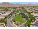 Aerial view of a green neighborhood park nestled amongst homes, promoting a sense of community at 2120 N Heritage St, Buckeye, AZ 85396