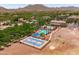 Aerial view of the blue community basketball court, pool, and clubhouse, all surrounded by mountains at 2120 N Heritage St, Buckeye, AZ 85396