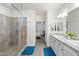 Bathroom featuring tile floors, dual sinks, and a glass-enclosed shower at 2120 N Heritage St, Buckeye, AZ 85396