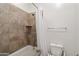 Bathroom highlighting the shower/tub combo with neutral tile surround at 2120 N Heritage St, Buckeye, AZ 85396