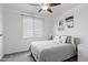 Cozy bedroom featuring a comfortable bed, neutral decor, ceiling fan, and a bright window at 2120 N Heritage St, Buckeye, AZ 85396