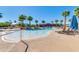 Inviting community pool features palm trees, lounge chairs, umbrellas and shallow wading area at 2120 N Heritage St, Buckeye, AZ 85396