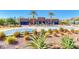 Community pool with palm trees, lounge chairs, splash pad and blue umbrellas at 2120 N Heritage St, Buckeye, AZ 85396