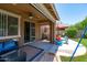 Inviting covered patio with comfortable seating and view of the backyard play area at 2120 N Heritage St, Buckeye, AZ 85396