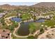 An aerial view shows a beautiful golf course with lakes and desert landscape for enjoyable golfing at 2120 N Heritage St, Buckeye, AZ 85396