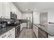 Bright eat-in kitchen features stainless steel appliances, granite counters and tiled backsplash at 2120 N Heritage St, Buckeye, AZ 85396