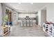 Open-concept kitchen with white cabinets, a breakfast bar, stainless steel appliances, and tiled flooring at 2120 N Heritage St, Buckeye, AZ 85396